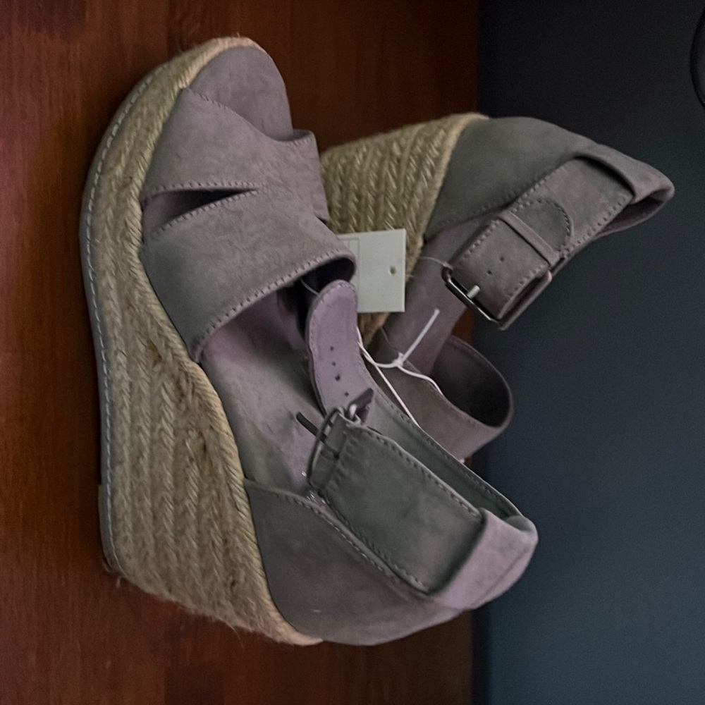 Woman’s grey wedges